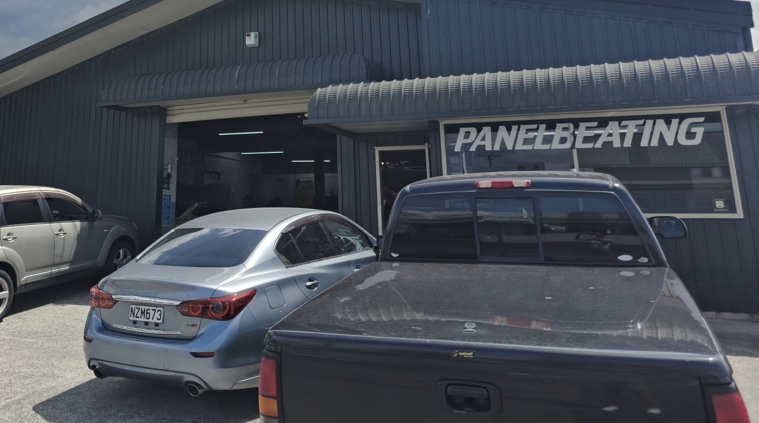 The Panelbeating workshop bay at Rob's Panel & Paint, roller door open